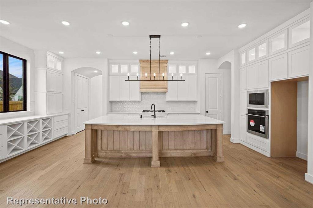 a large white kitchen with a large window