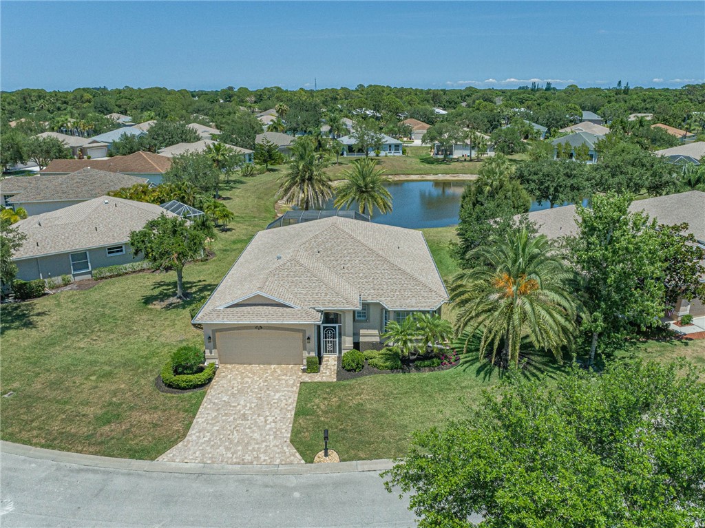 an aerial view of a house with yard and green space