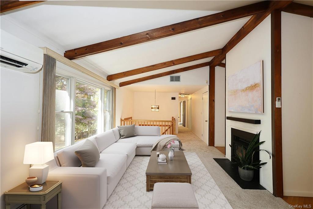 a living room with furniture and a floor to ceiling window