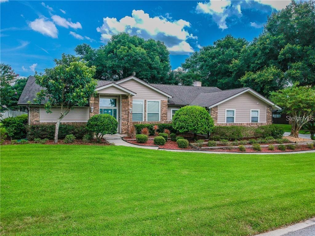 a front view of house with yard and green space