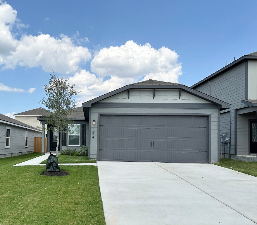 a front view of a house with a yard and garage