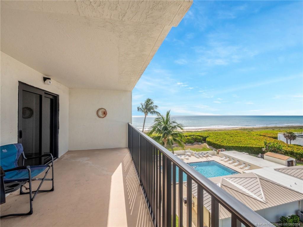 a view of a balcony with an ocean