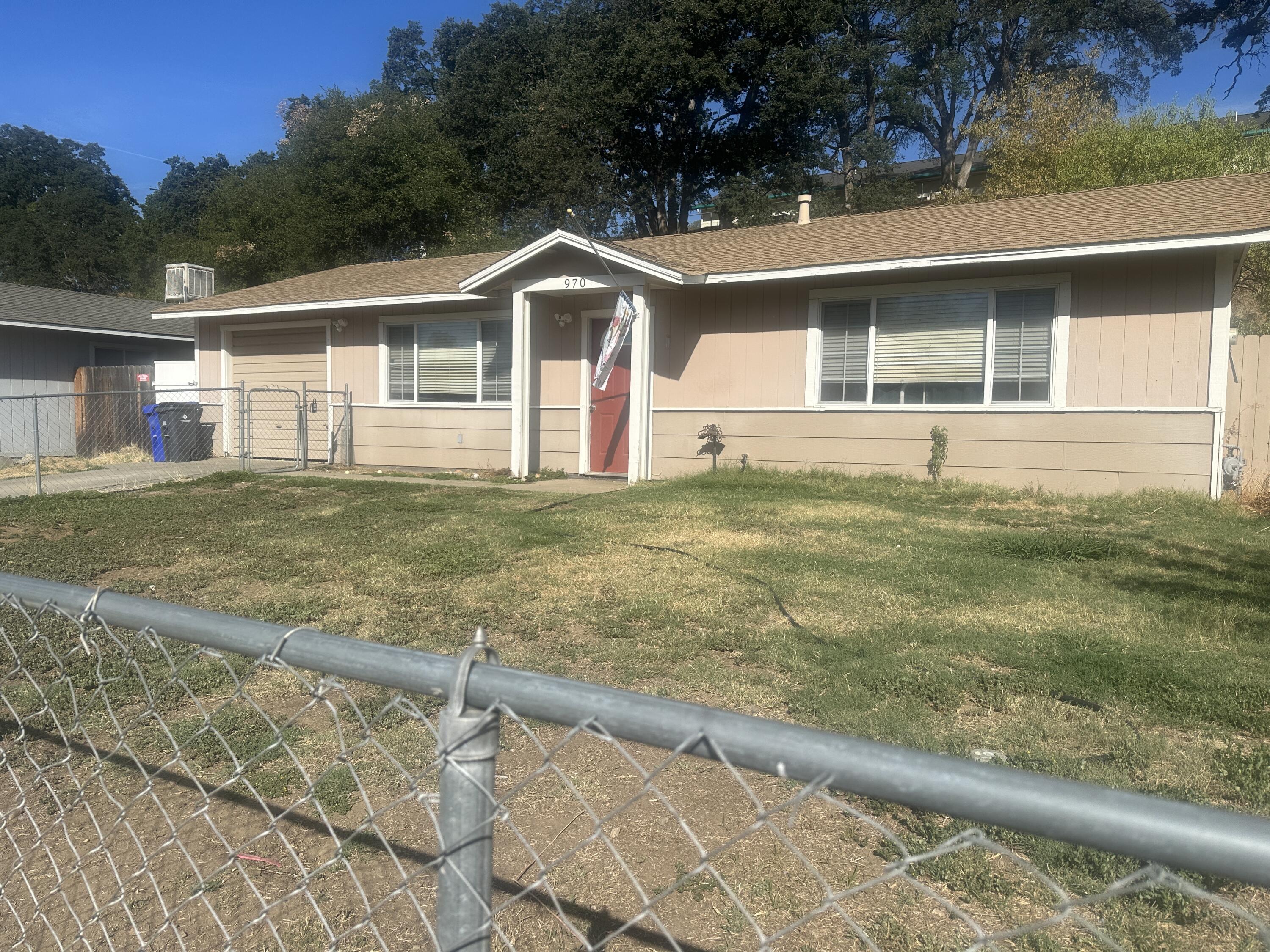 a view of a yard in front of a house with a big yard