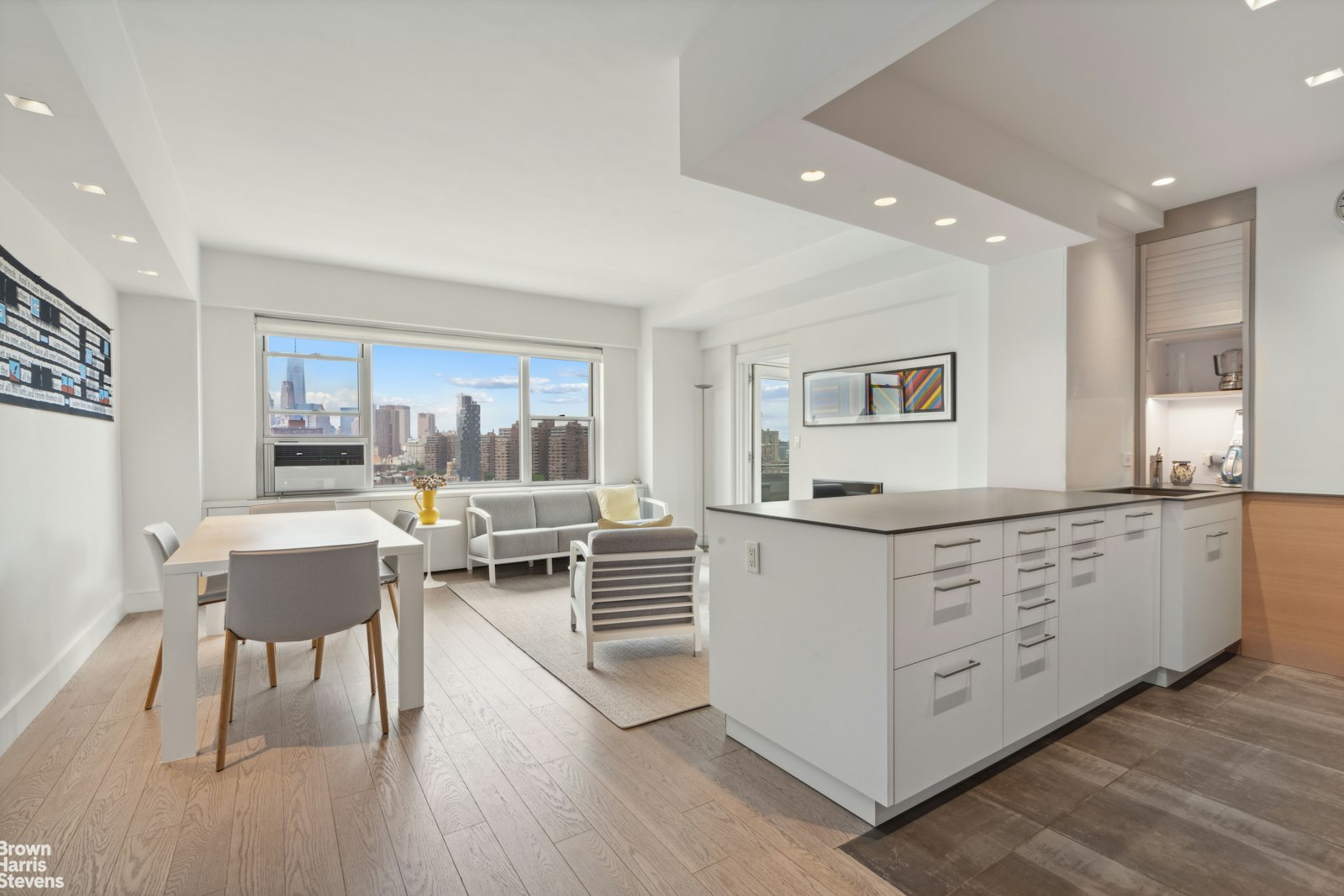 a living room with furniture a dining table and a large window