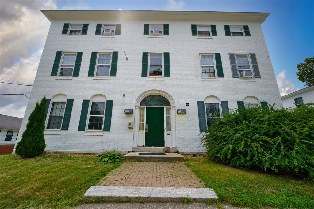 a front view of a house with garden