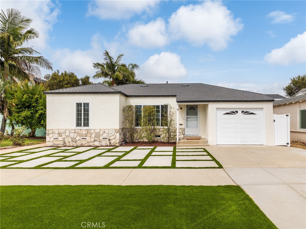 a front view of a house with a garden and patio