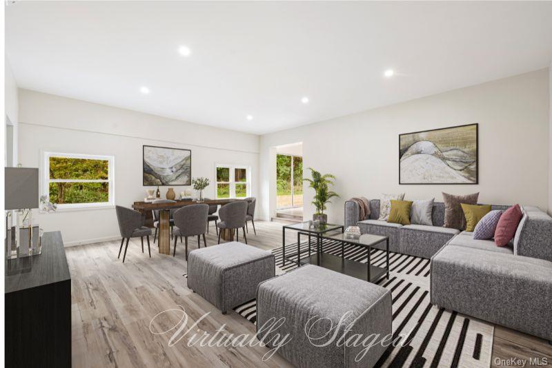 a living room with furniture and a potted plant