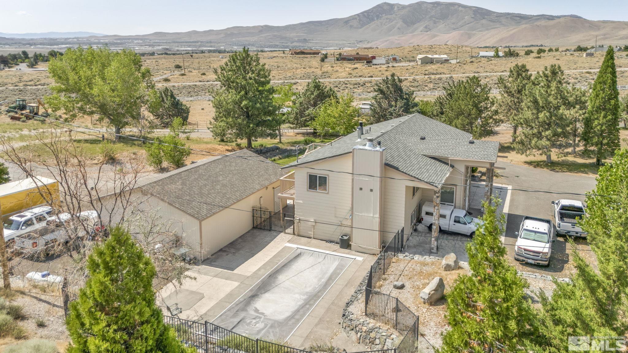 aerial view of a house with a yard and balcony