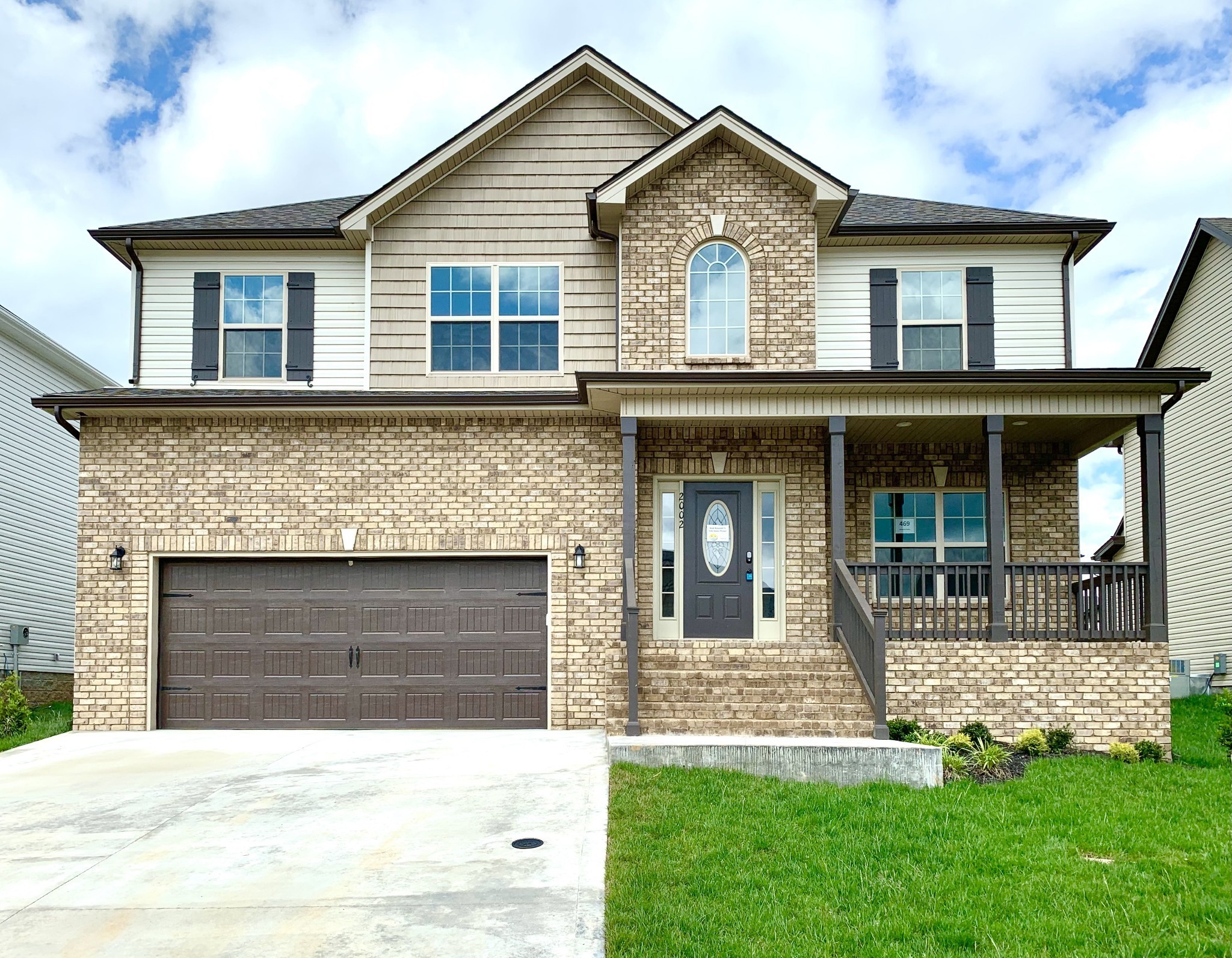 a front view of a house with a yard and garage