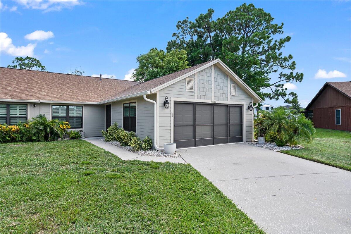 a front view of a house with a yard and garage