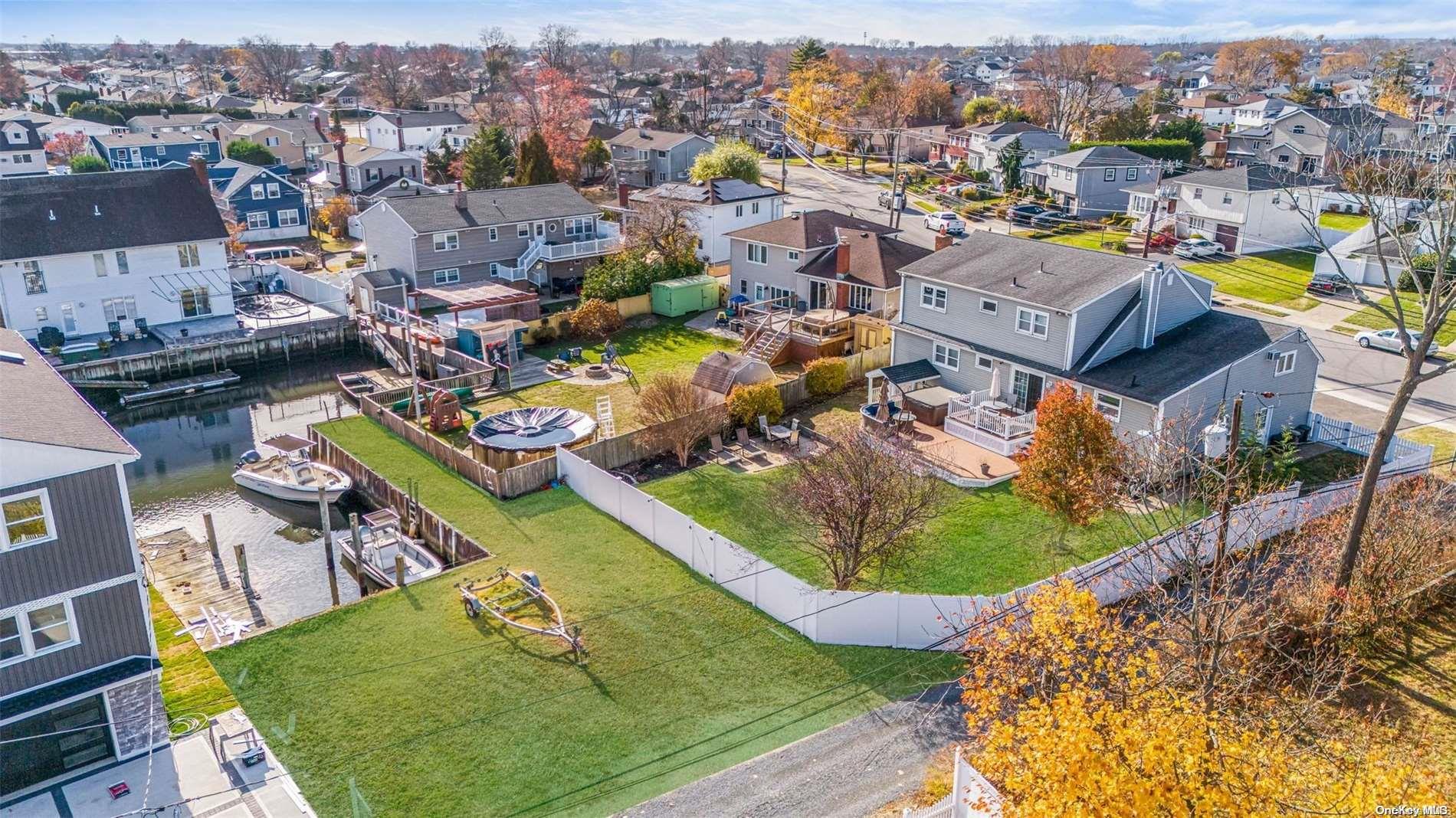 an aerial view of a house with a swimming pool yard and outdoor seating