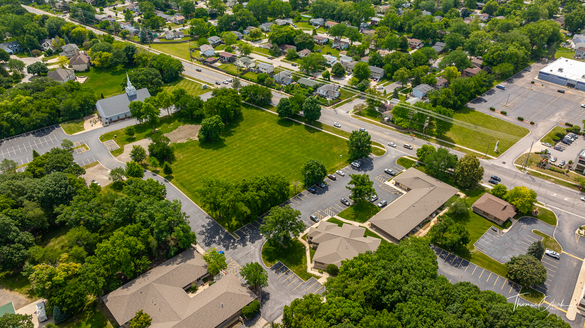 an aerial view of residential house with outdoor space and trees all around