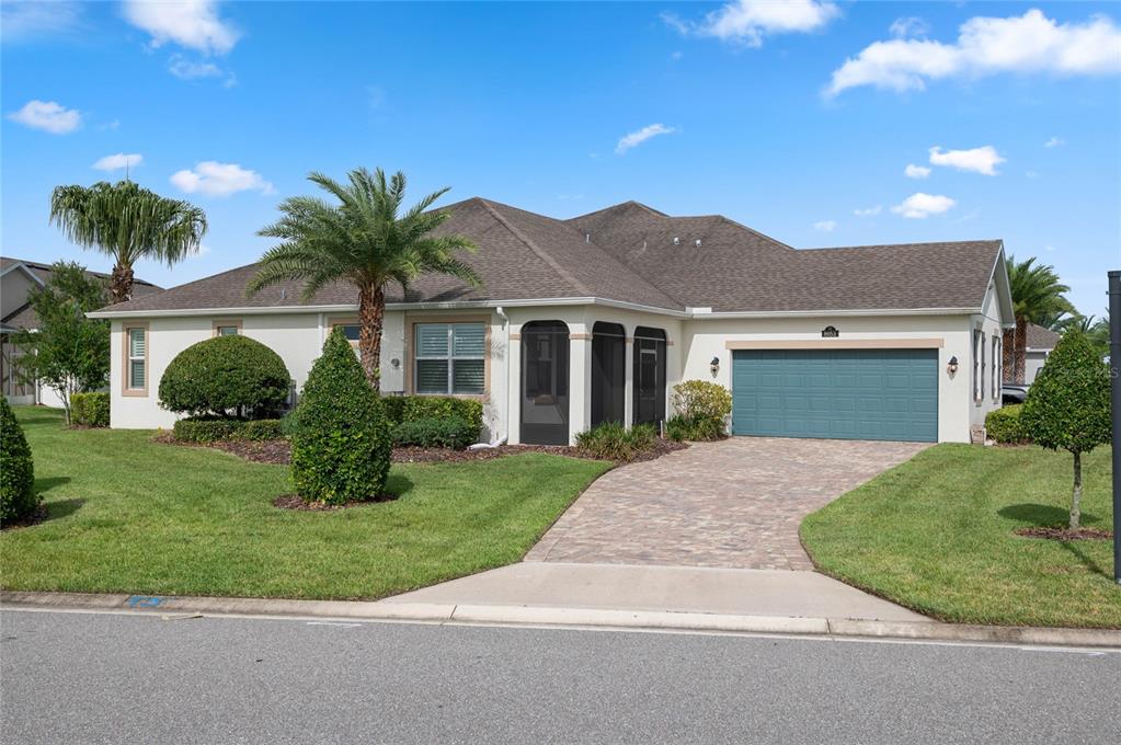 a front view of a house with a garden and yard