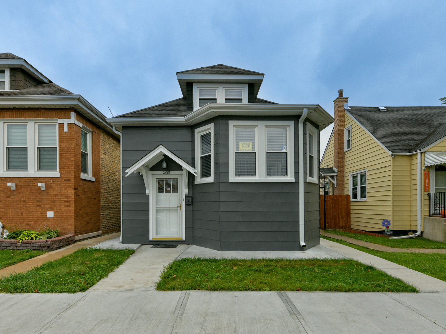 a front view of a house with a garden