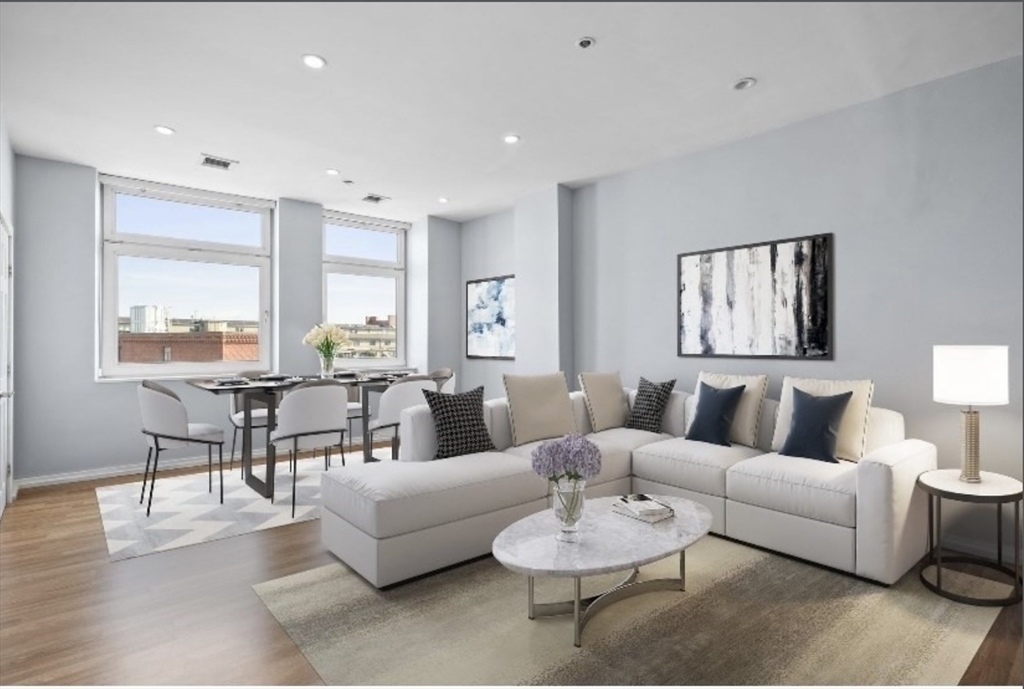 a living room with furniture and a potted plant