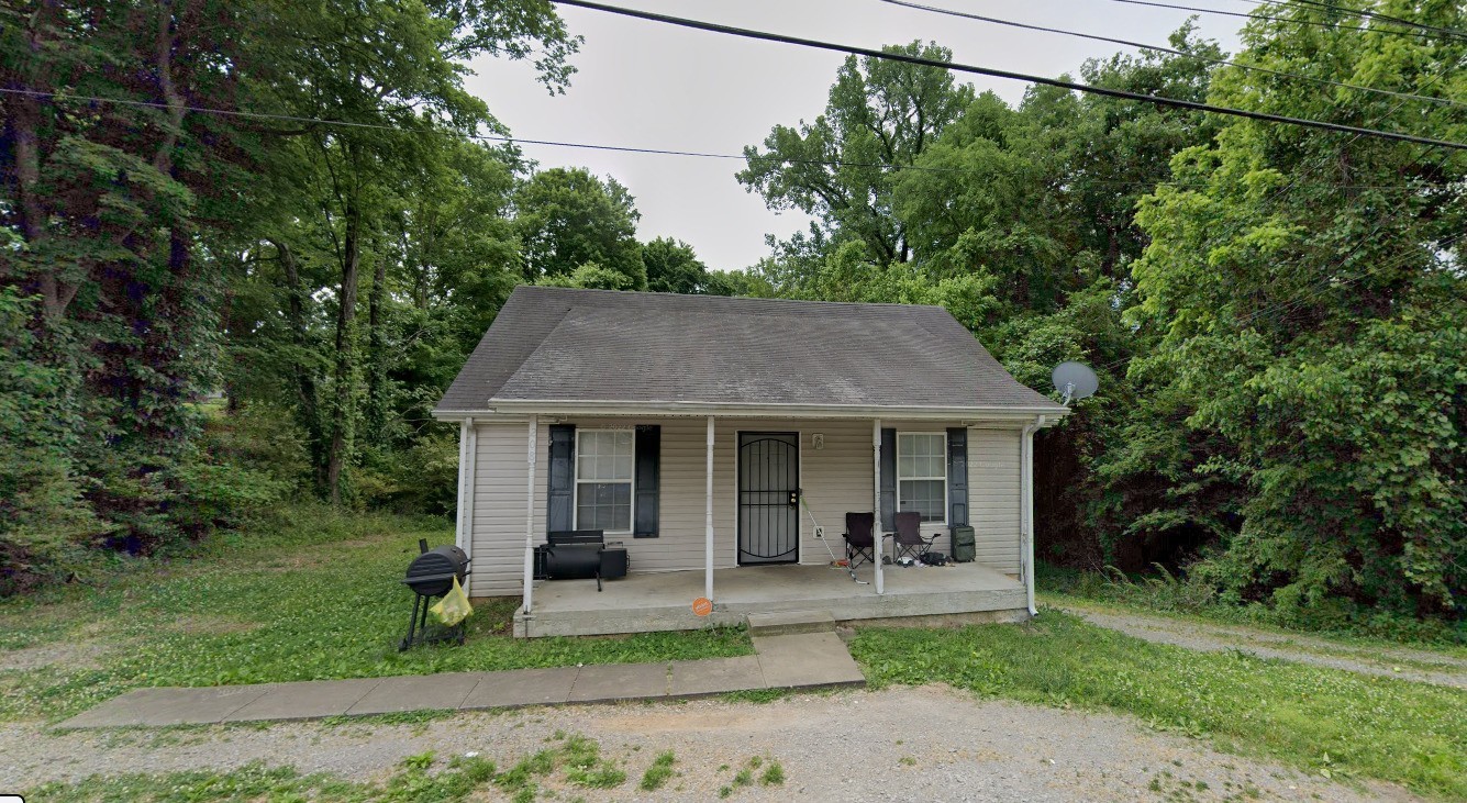 a view of a house with a yard and plants