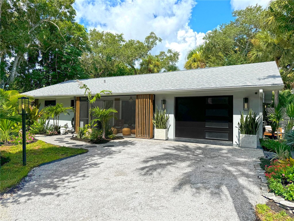 a view of a house with backyard porch and sitting area