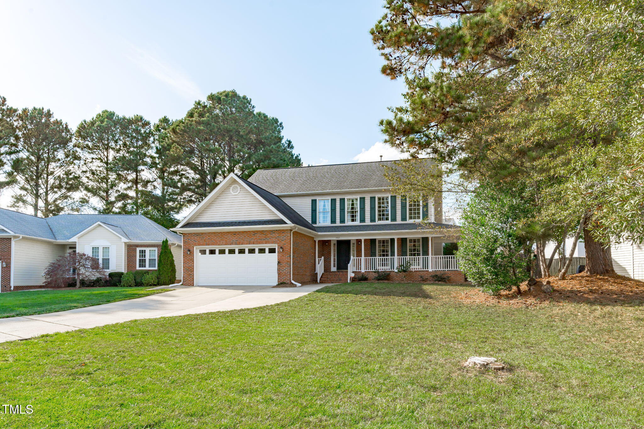 a front view of house with yard and green space