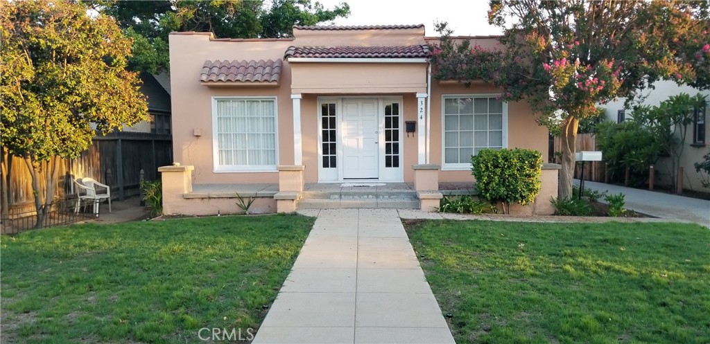 a front view of a house with garden