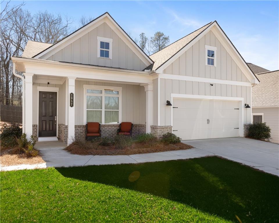 a front view of a house with a yard and outdoor seating