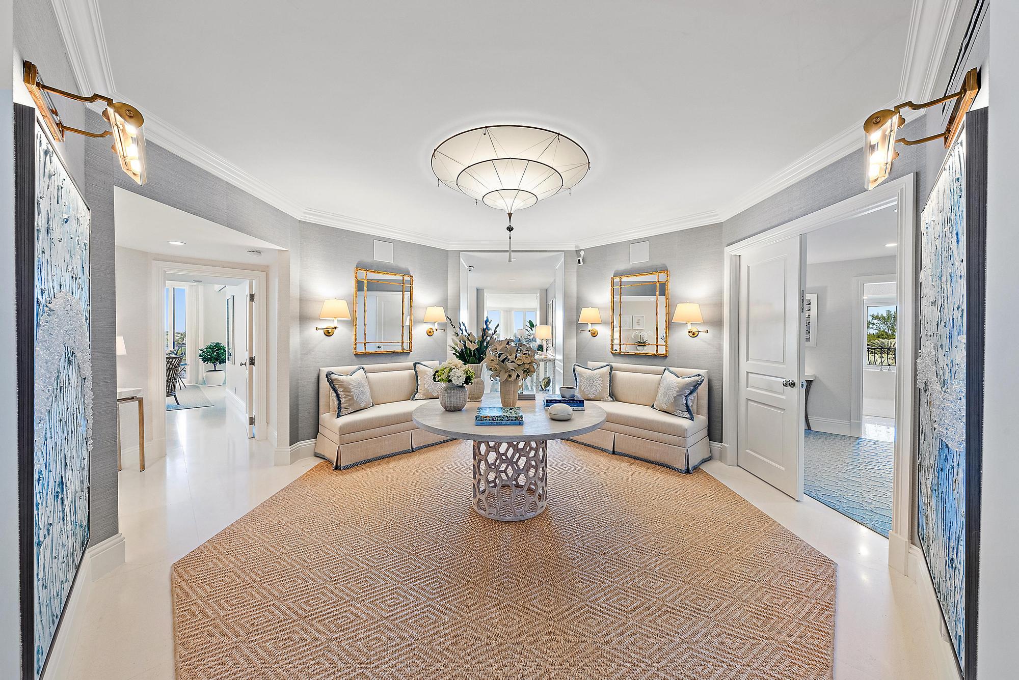 a living room with furniture and a chandelier