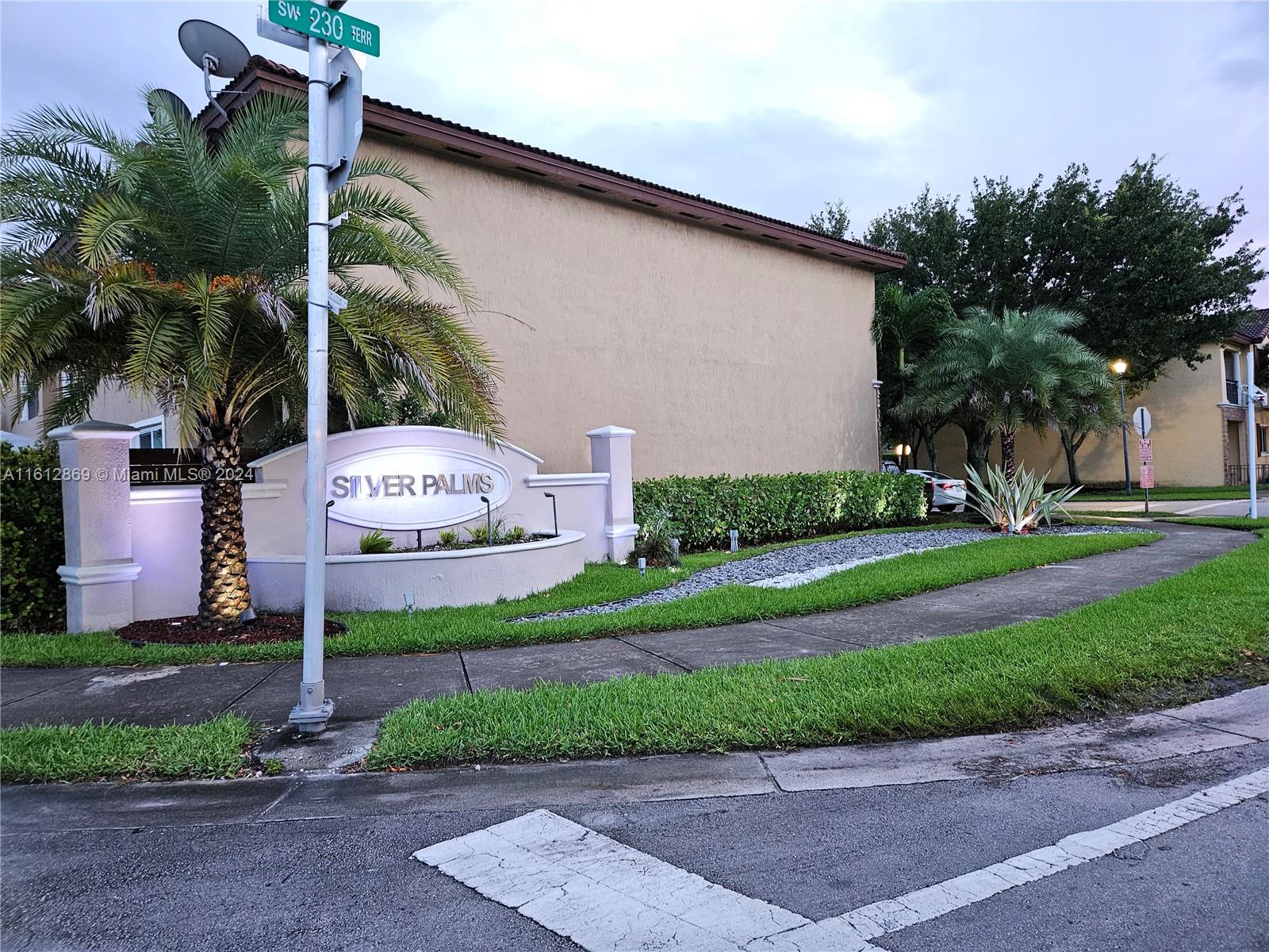 a front view of a house with a yard and a garage