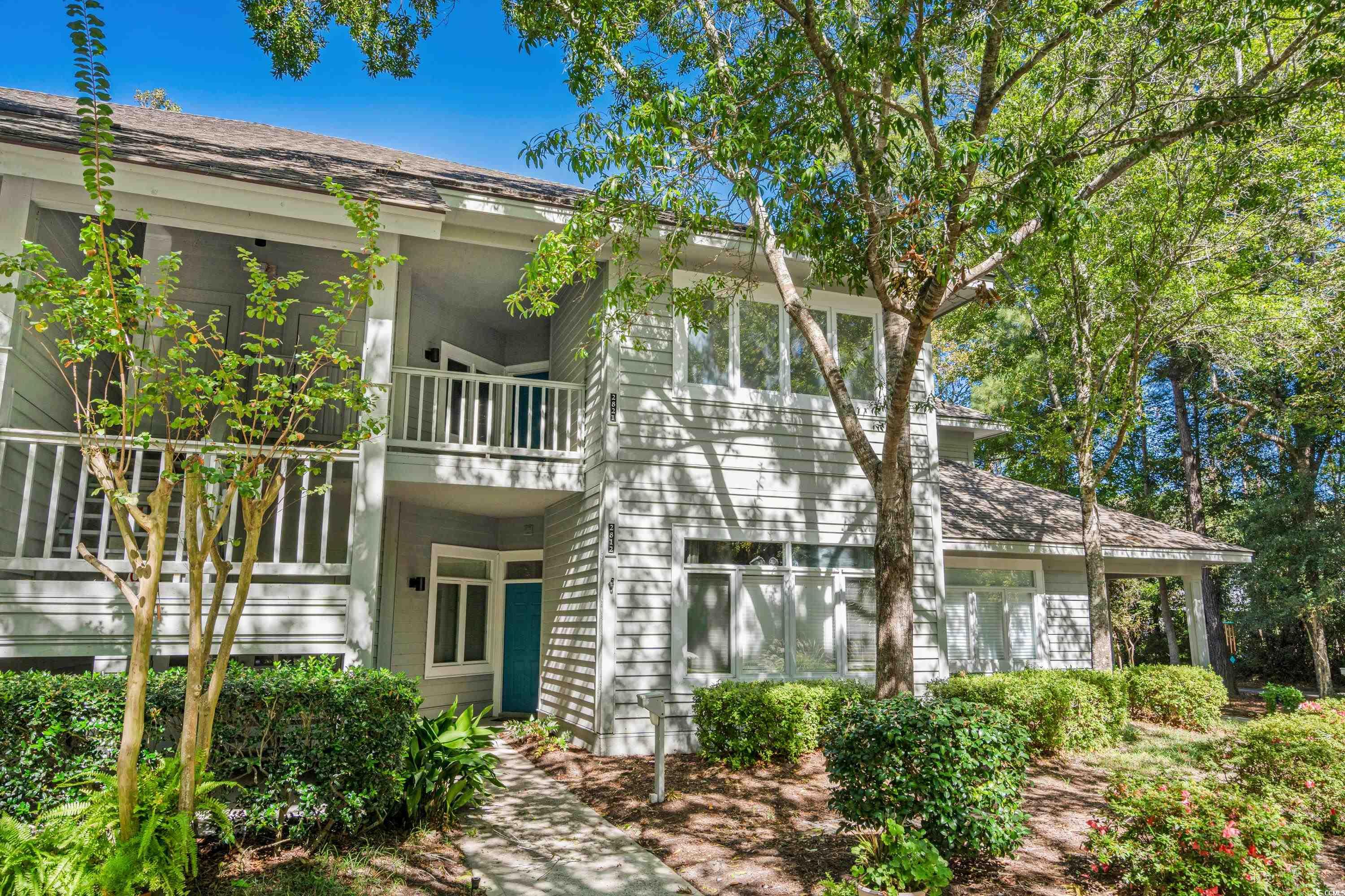 View of front of house featuring a balcony