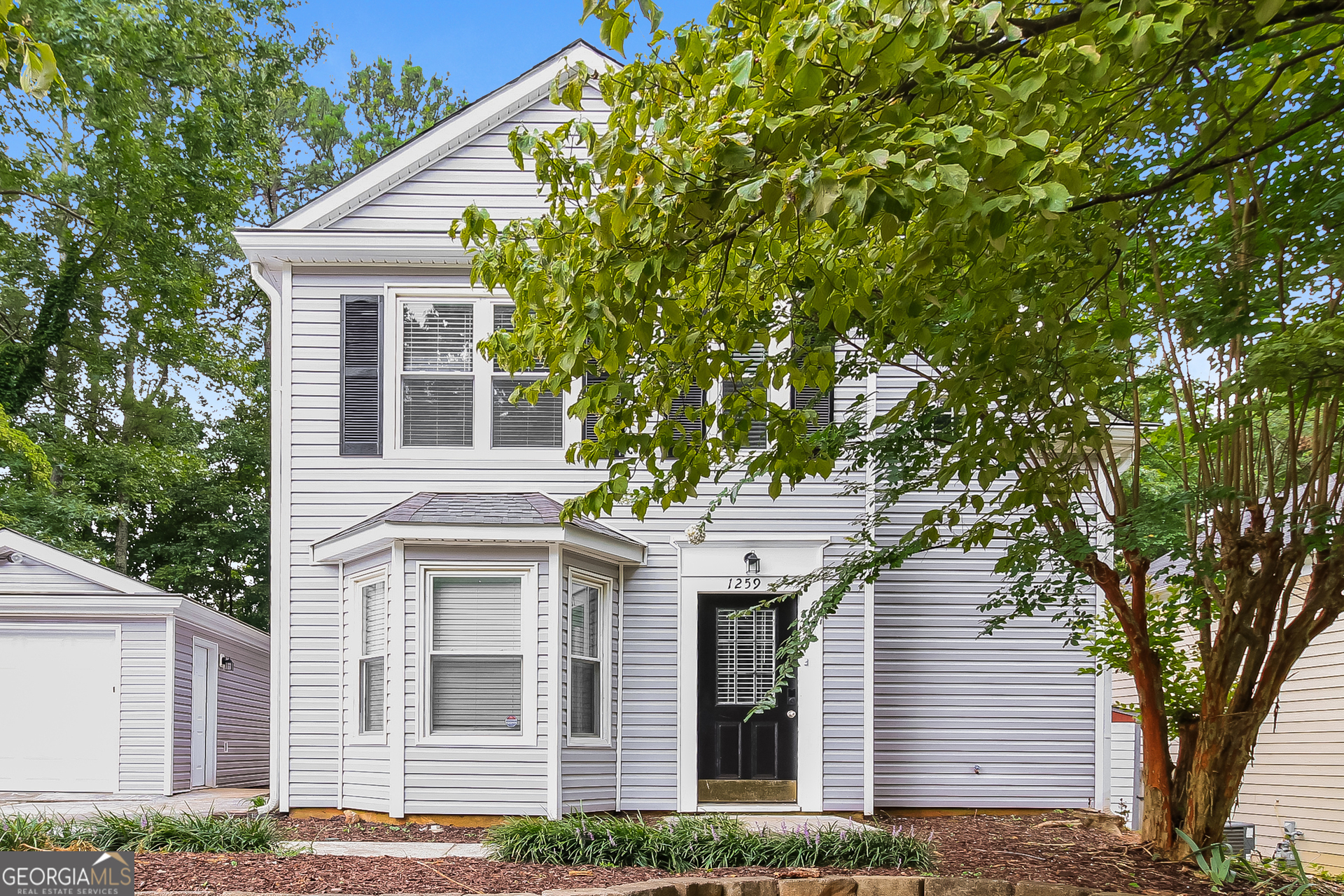 a view of a house with a tree