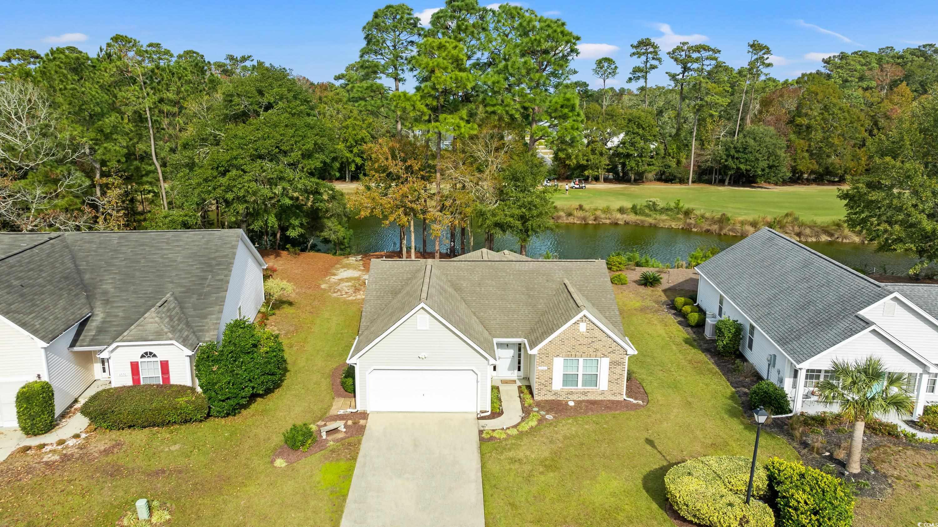 Birds eye view of property with a water view