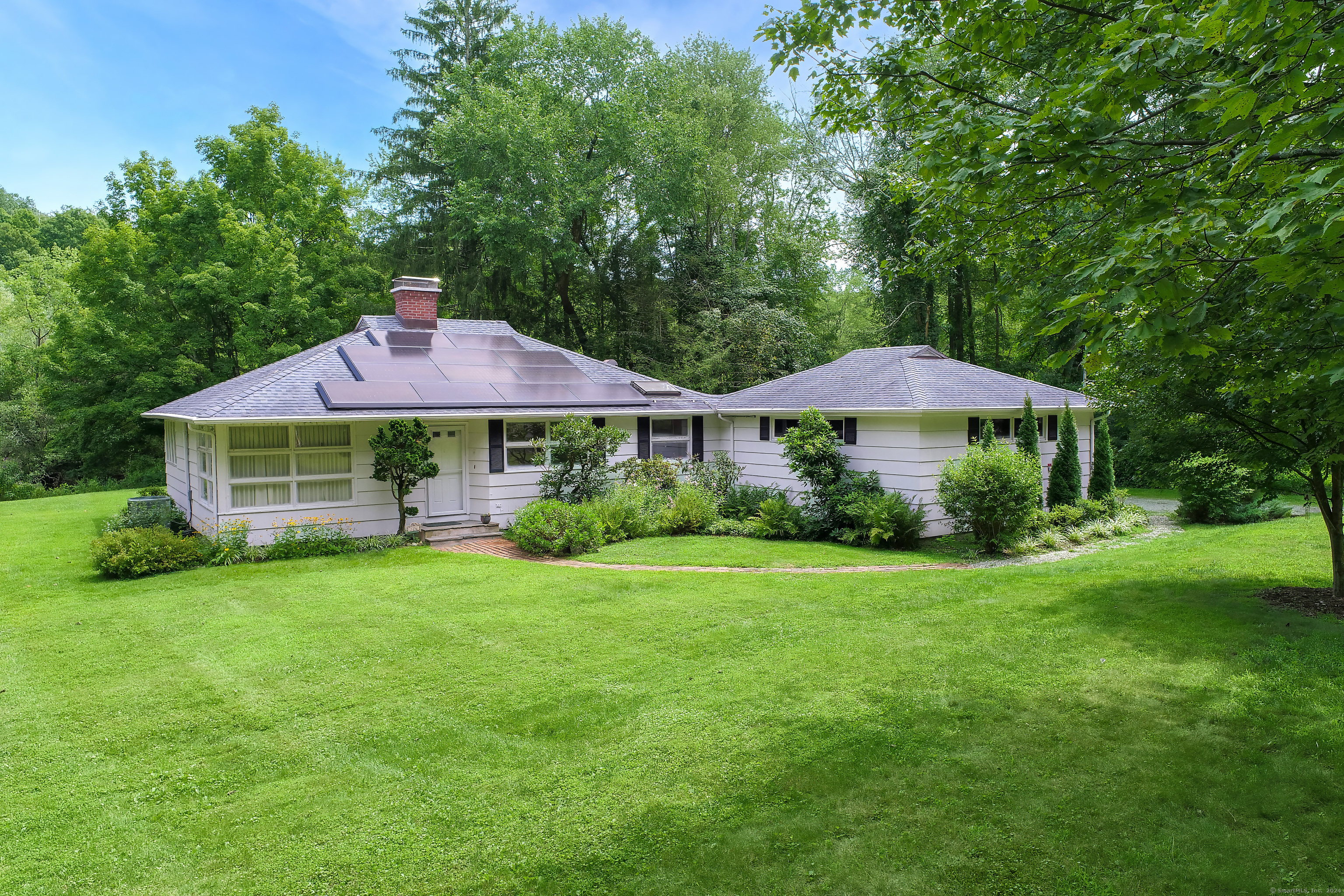 a front view of a house with garden