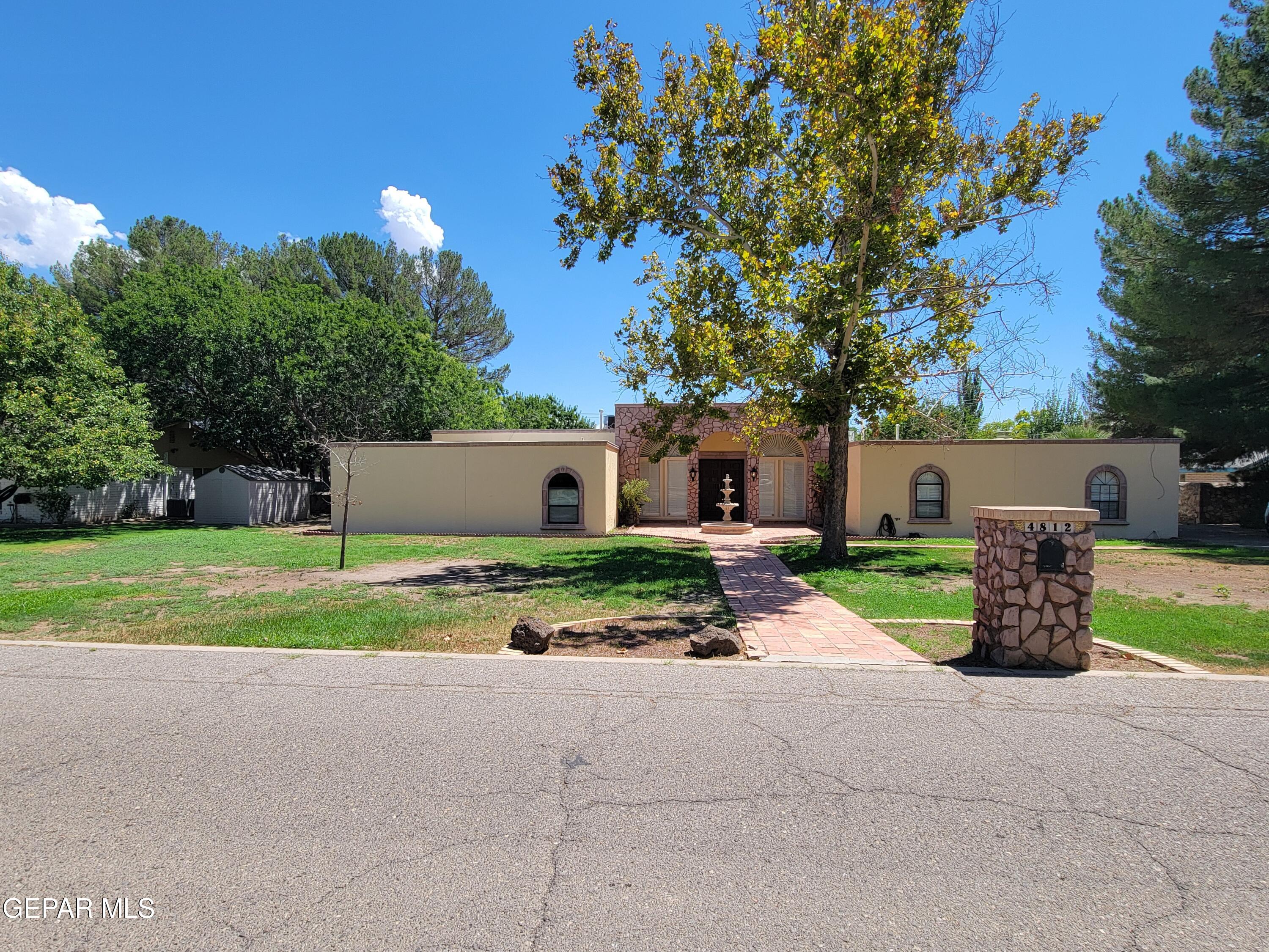 a view of a house with backyard and a garden