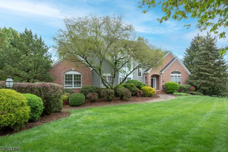 a front view of a house with a garden and plants