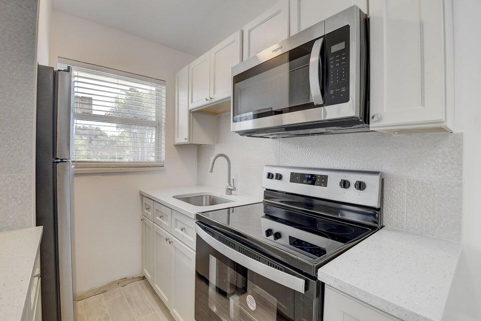 a kitchen with a stove microwave and sink