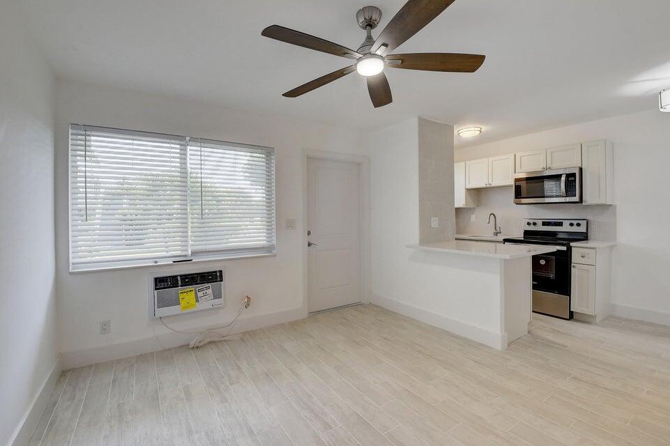 a kitchen with a refrigerator and a stove top oven