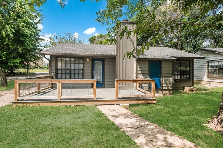 a view of a house with backyard porch and sitting area