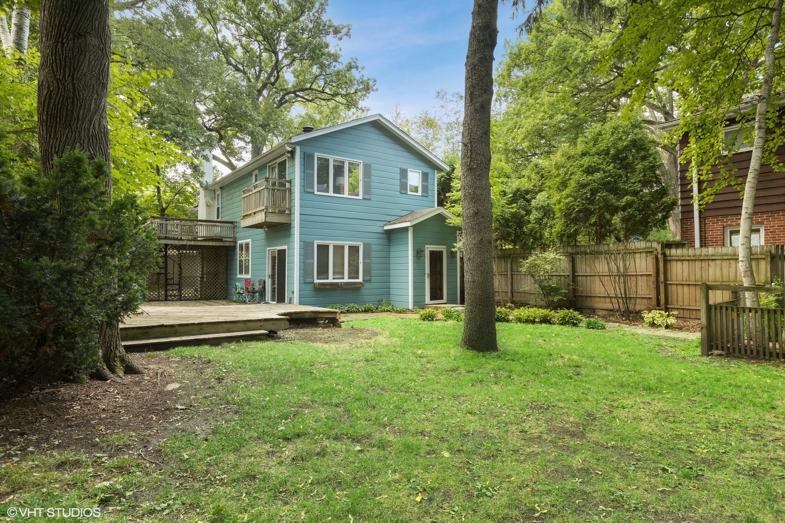 a view of a house with a yard and sitting area