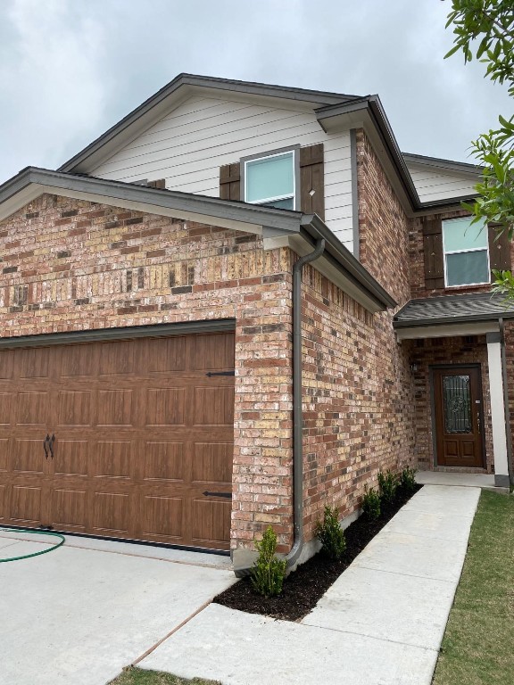 a front view of a house with garage