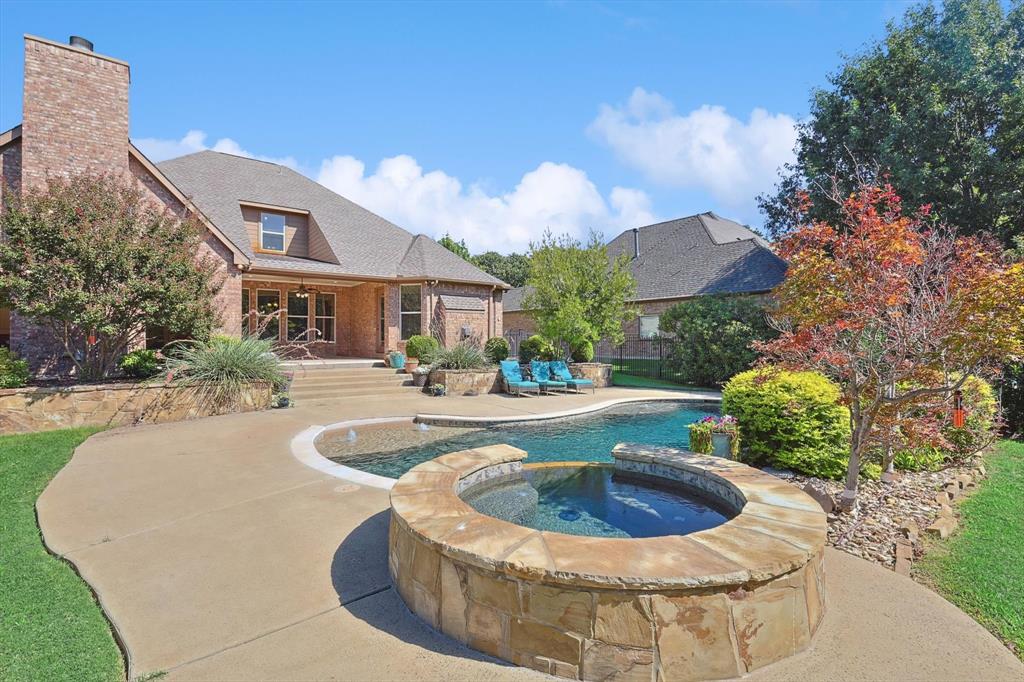 a view of a house with swimming pool and a yard