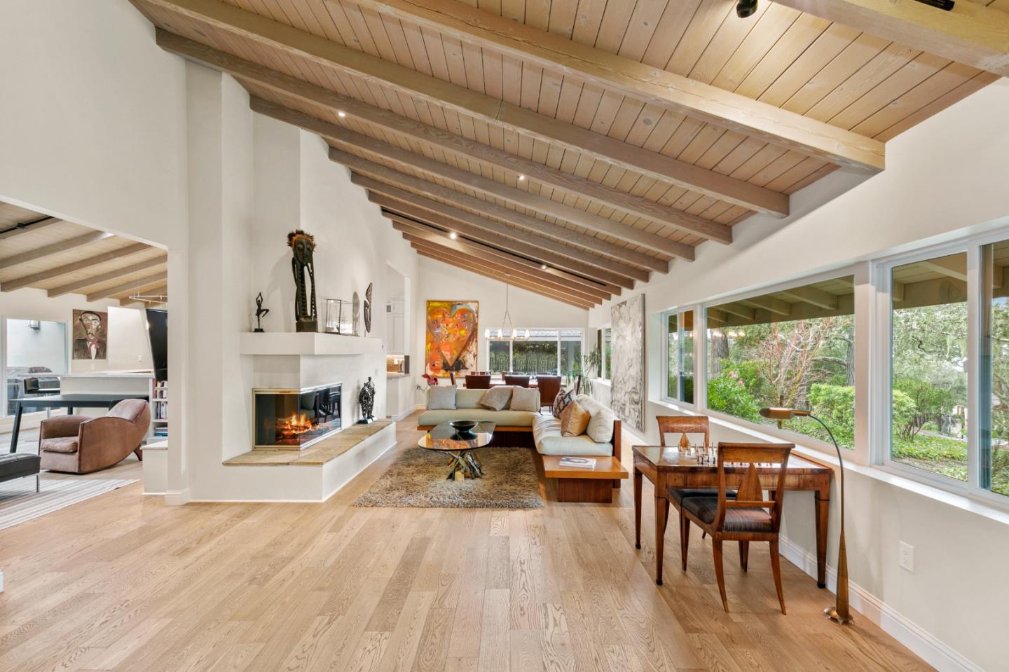 a living room with furniture large window and fireplace