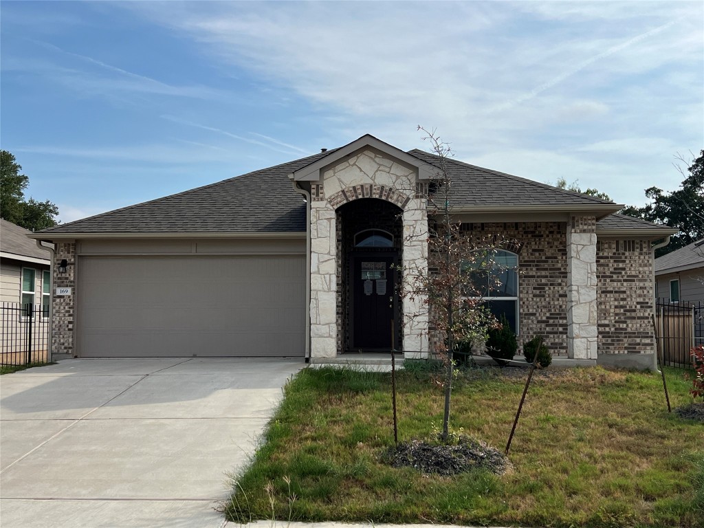 a front view of a house with garden