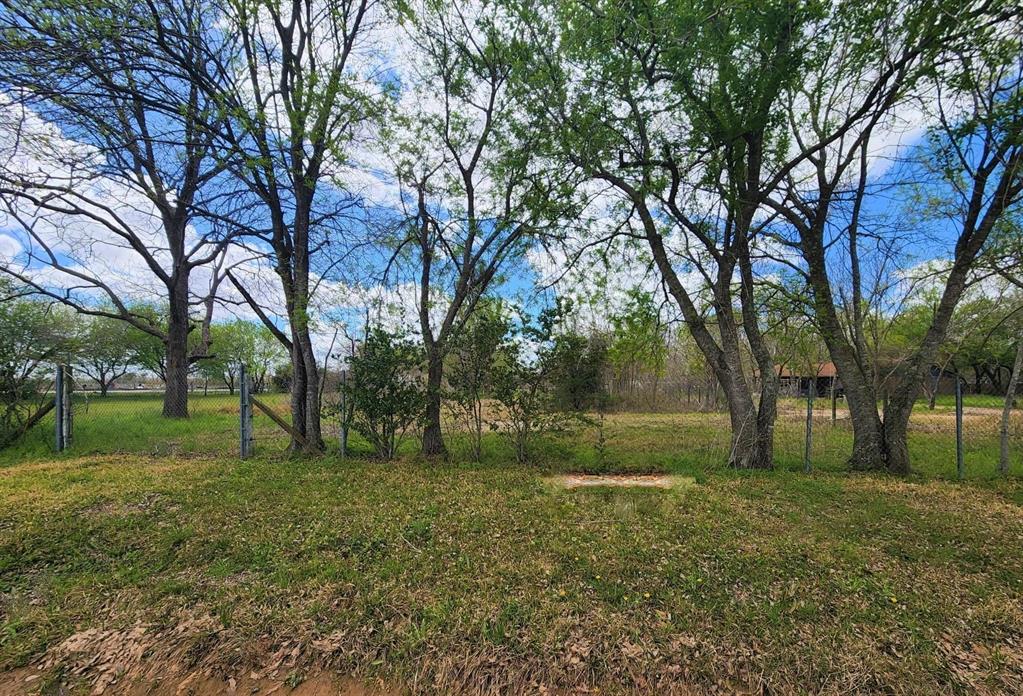 a view of backyard with huge green field