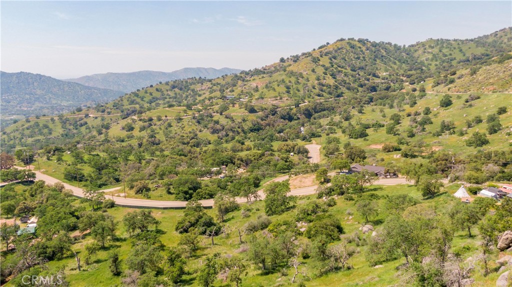 a view of a field with a mountain in the background