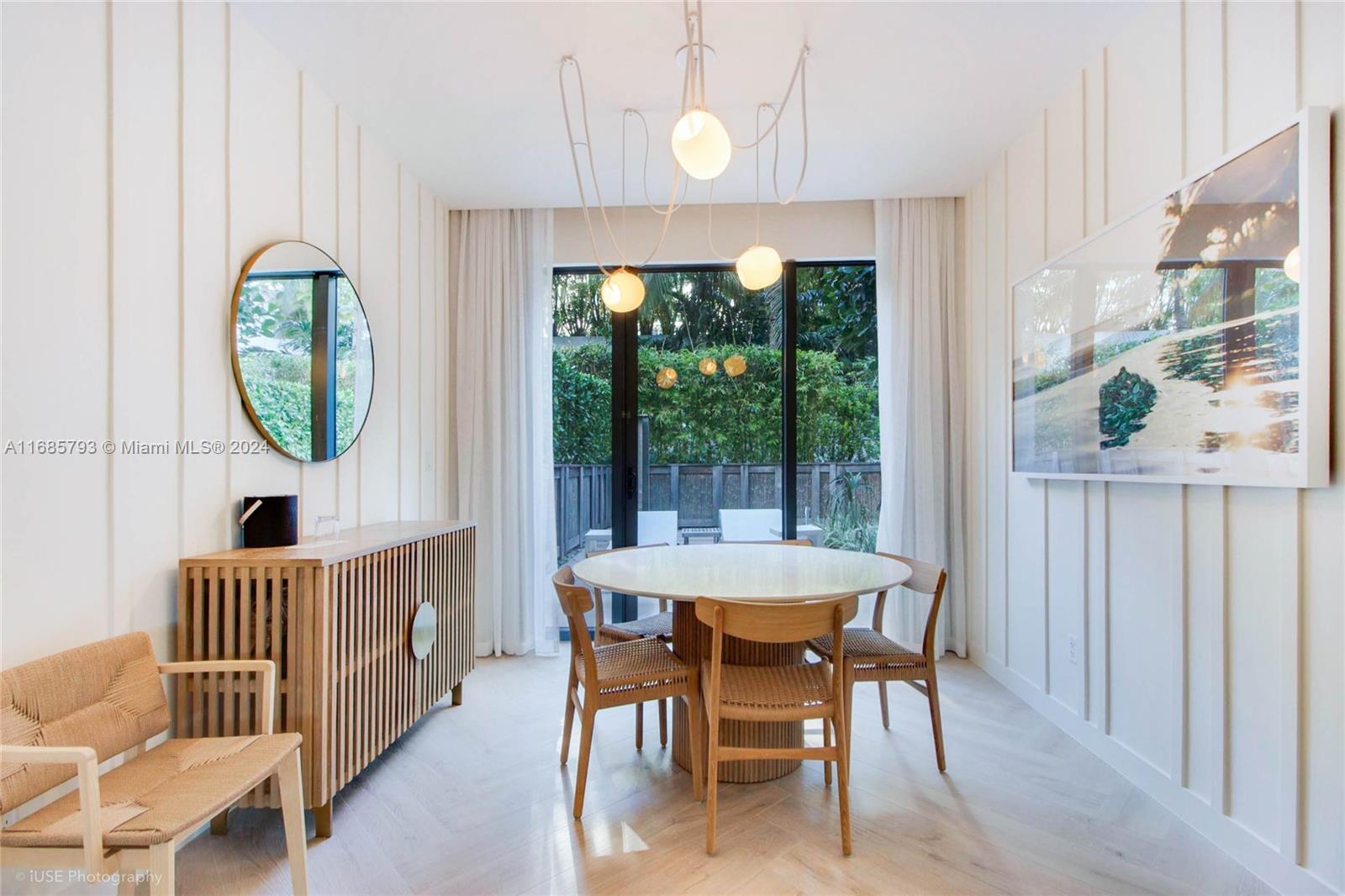 a dining room with furniture a rug and a large window