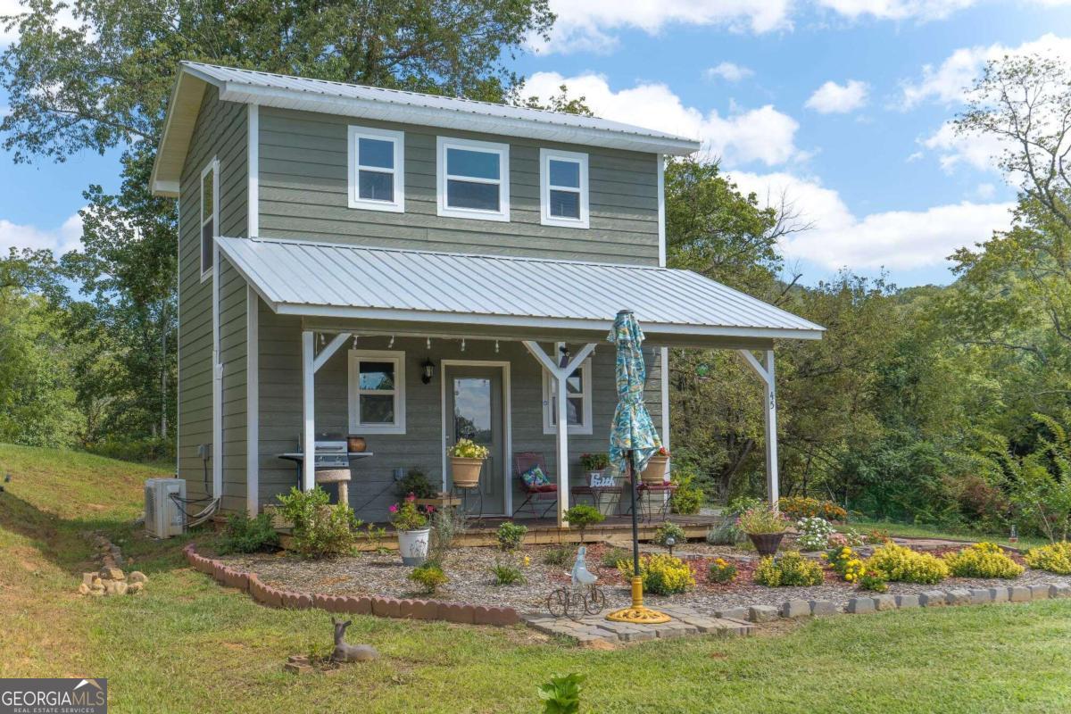 a front view of a house with garden