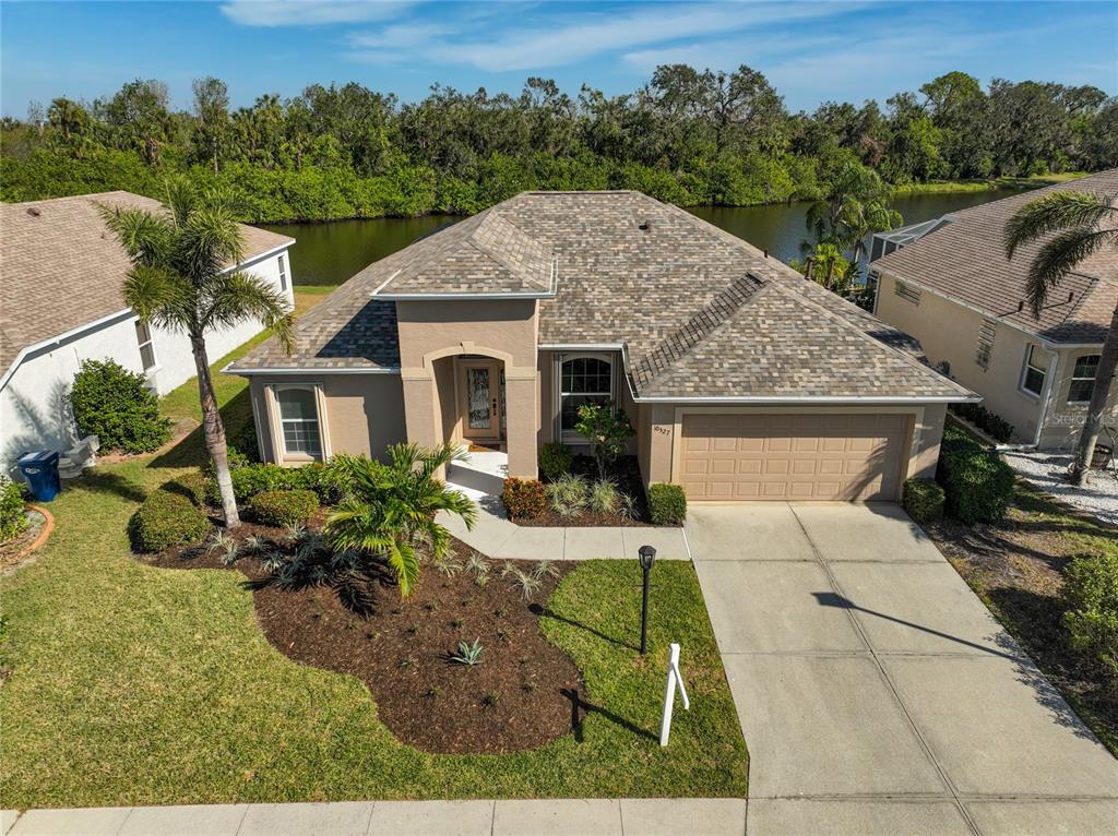 an aerial view of a house with yard porch and furniture