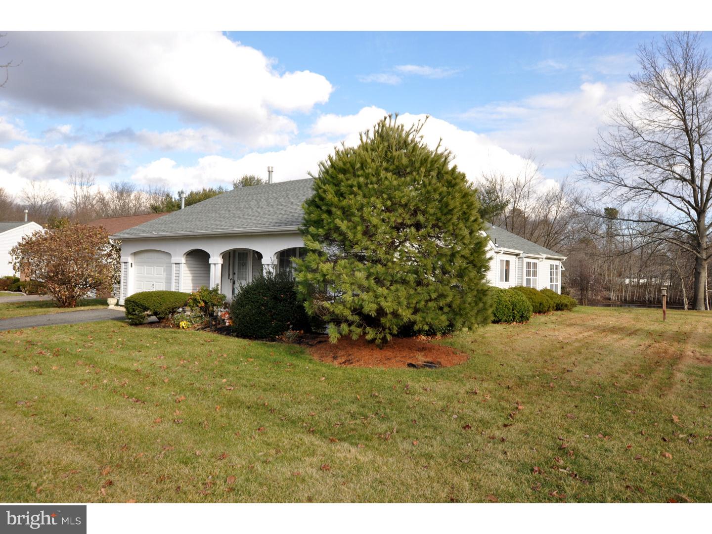 a view of a house with a big yard and large tree