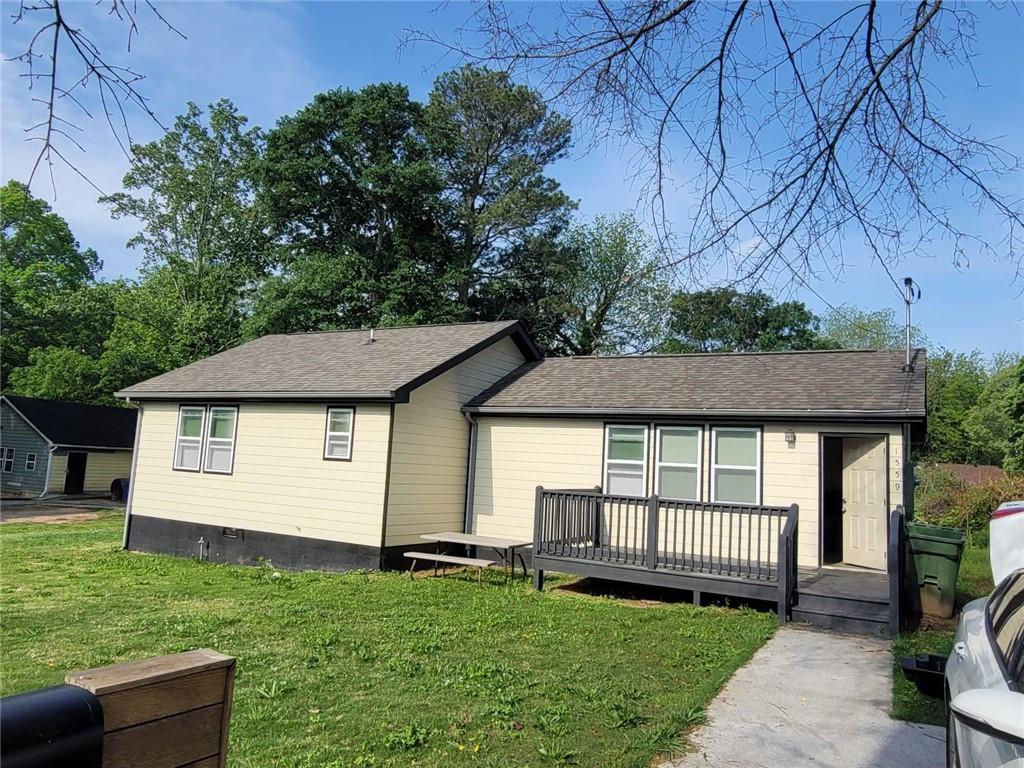 a front view of a house with a garden and deck