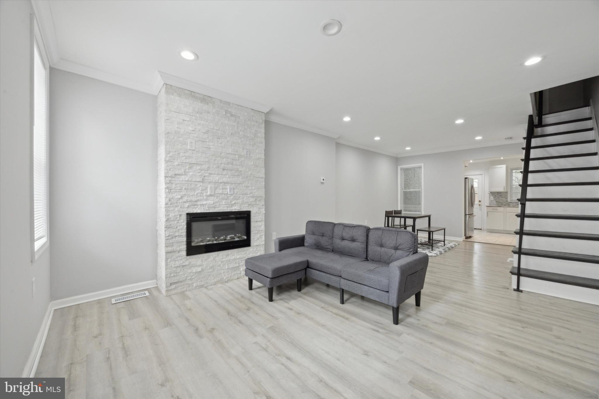 a living room with furniture and a fireplace