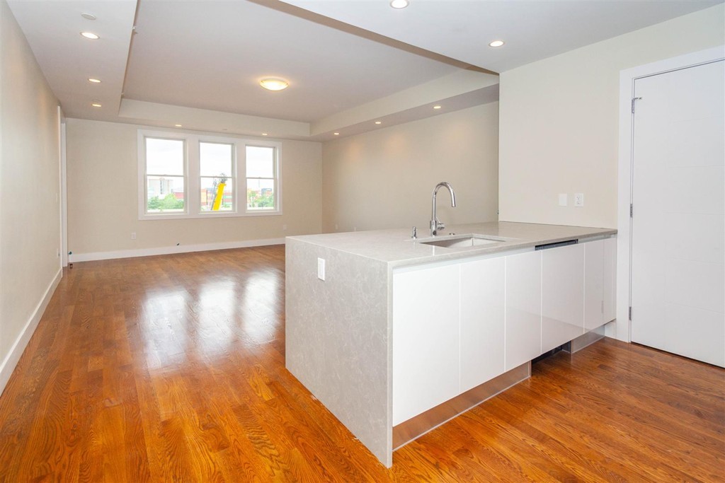 a view of a kitchen cabinets a wooden floor and a window