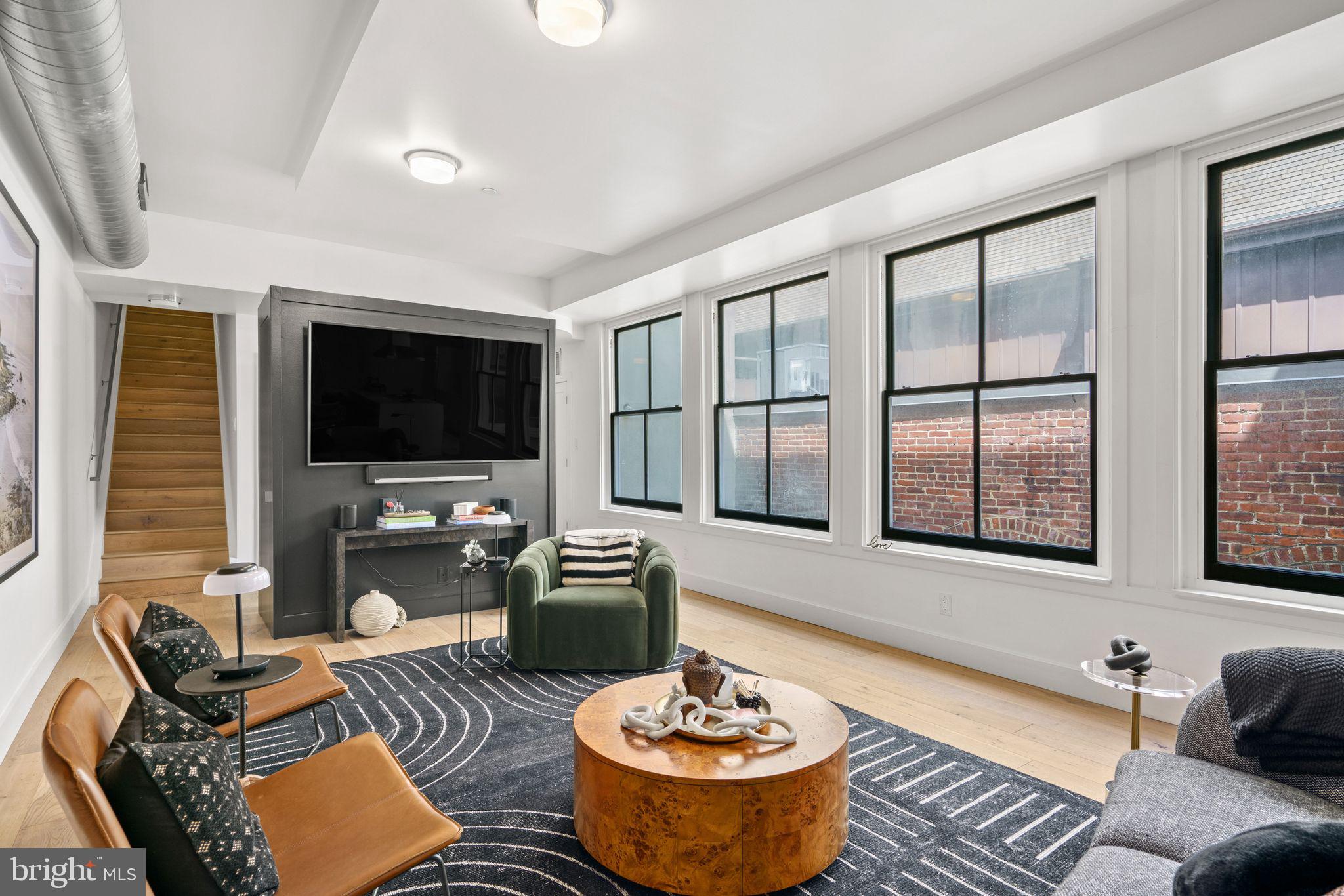 a living room with furniture fireplace and a flat screen tv